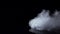 White fog swirls on isolated black studio background, slow motion