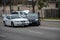 A white Ford Mustang and black Toyota Prium sit in the middle of the road after an accident