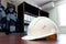 White foreman helmet for conceptual design, office interior on construction site. Industry, mechanical engineering