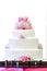 White four tiered wedding cake on table