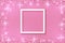 White frame on Festive pink background. Shining stars on light pink pastel background. Christmas. Wedding. Birthday