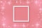 White frame on Festive pink background. Shining stars on light pink pastel background. Christmas. Wedding. Birthday