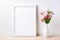 White frame mockup with pink flowers in elegant vase