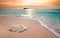 White frangipani plumeria flowers on sand at the beach front of the ocean waves background