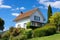 white french country house with a steep hipped roof under a blue sky