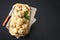 White fresh champignons with parsley on a wooden board on a gray dark table. Mushrooms. Copy the space. Top view.