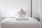 White fresh towel on single bed in bedroom