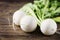 White fresh turnip on the wooden table