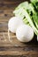 White fresh turnip on the wooden table