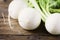 White fresh turnip on the wooden table