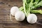 White fresh turnip on the wooden table