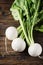 White fresh turnip on the wooden table