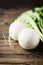 White fresh turnip on the wooden table