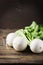 White fresh turnip on the wooden table