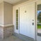 White front door with door knocker and glass panes