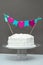 White frosting vanilla birthday cake with celebration banner. Gr