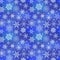 White frozen snowflakes on blue winter background, seamless pattern