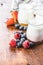 White fruity yogurt in jar and blueberry, raspberry, strawberry