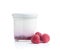 White fruity yogurt in jar an raspberries