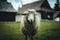 White-furred sheep in a lush, green field, with a  barn in the background