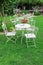 White garden furniture in beautiful garden.