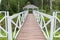 White gazebo in the Park on the island, around the green island on a summer day in the tall lush grass among