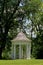 White gazebo under trees