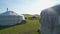 White Ger Tents And Ox Cart Tumbrel in Meadows of Mongolia