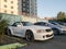 White German sedan of the brand Mercedes model w 124 in the configuration of a convertible with a folding roof in a parking lot in