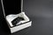 White gift box with car keys with remote control alarm system on black background with copy space. St Valentine holiday