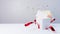 White gift box with red ribbon opens with a deflagration of confetti and a blank letter appears