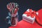 White gift box with red ribbon and paper straws