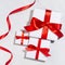 White gift different size boxes with red silk bow, ribbon on white wood table, top view, square, valentine\\\'s day background.