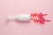 White glass of champagne with hearts on a straw on a pink background. Love minimal concept