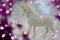 The white glittering unicorn with glitters and a gold corner in the middle of a purple circle with stars.