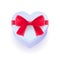 White glossy gift box in heart shape with red bow