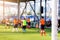 White goalposts and mesh of goal with blurry football players.