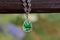 White gold necklace Set with emerald surrounded by diamonds