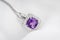 White gold pendant with rose violet amethyst and diamonds on soft blurred background