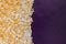 White, Gold, Shiny and Tiny Sugar Balls Background on Purple Velvet Background Surface with Free Space