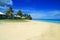 White golden sand and coral blue sea waters with Polynesian beachfront houses- beach fales, Manase, Samoa, Savai`i