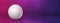 White golf ball on a purple studio banner