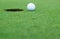 White golf ball on putting green