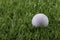 White Golf ball on synthetic artificial turf.