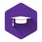 White Graduation cap icon isolated with long shadow. Graduation hat with tassel icon. Purple hexagon button