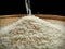 white grain rice poured into traditional flat bamboo basket