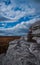 White granite outcropping under cloudy blue sky at Sam\'s Point Preserve