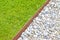 White gravel floor and fresh green lawn with clovers and rusty metal containment profiles