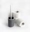 White and gray plastic toilet brush and roll of toilet paper on white background