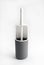 White and gray plastic toilet brush on white background